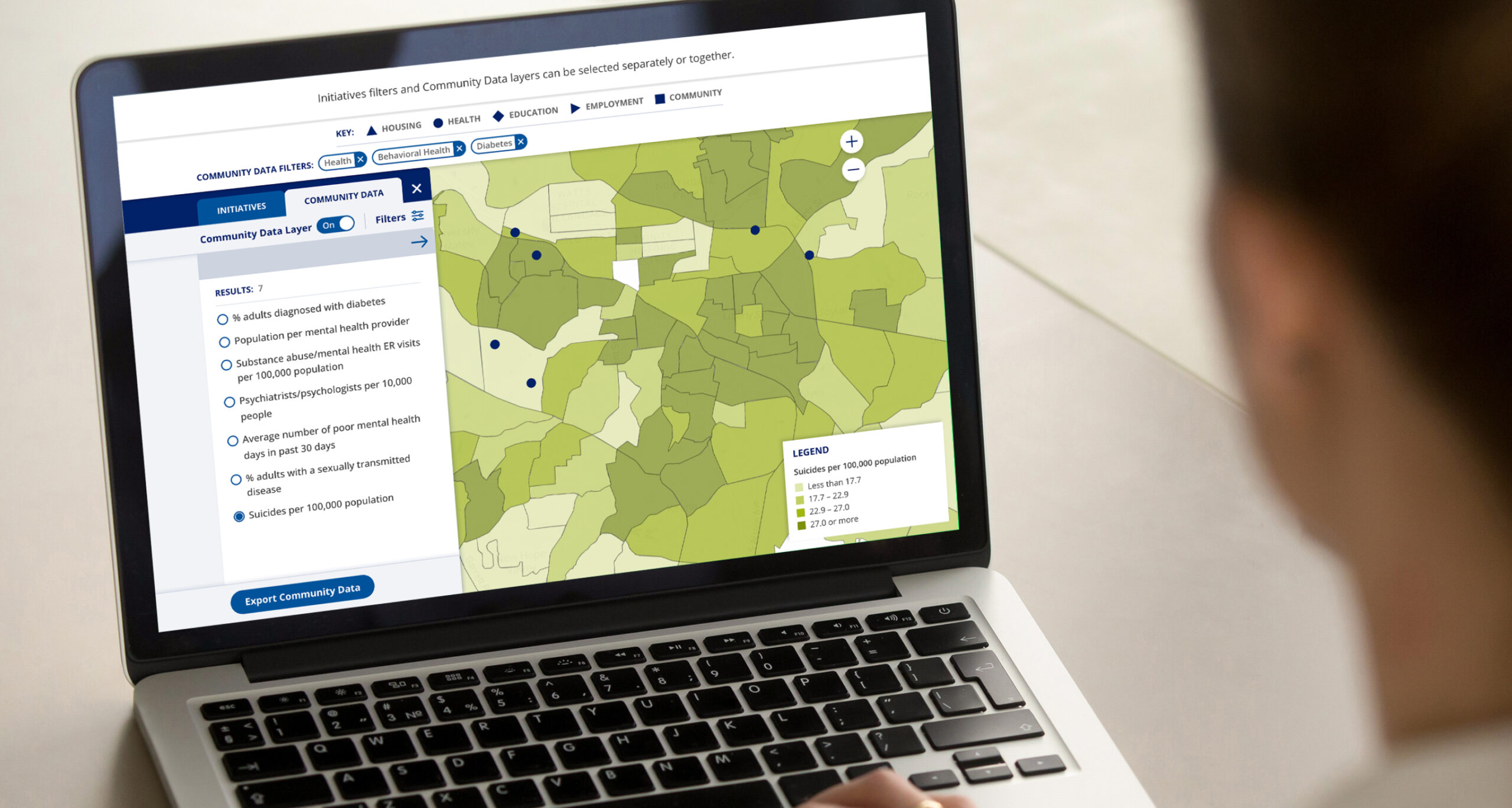 person utilizing a SDOH platform on their laptop